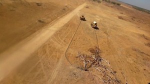 Bulldozers with chains clearing vegetation in Queensland.